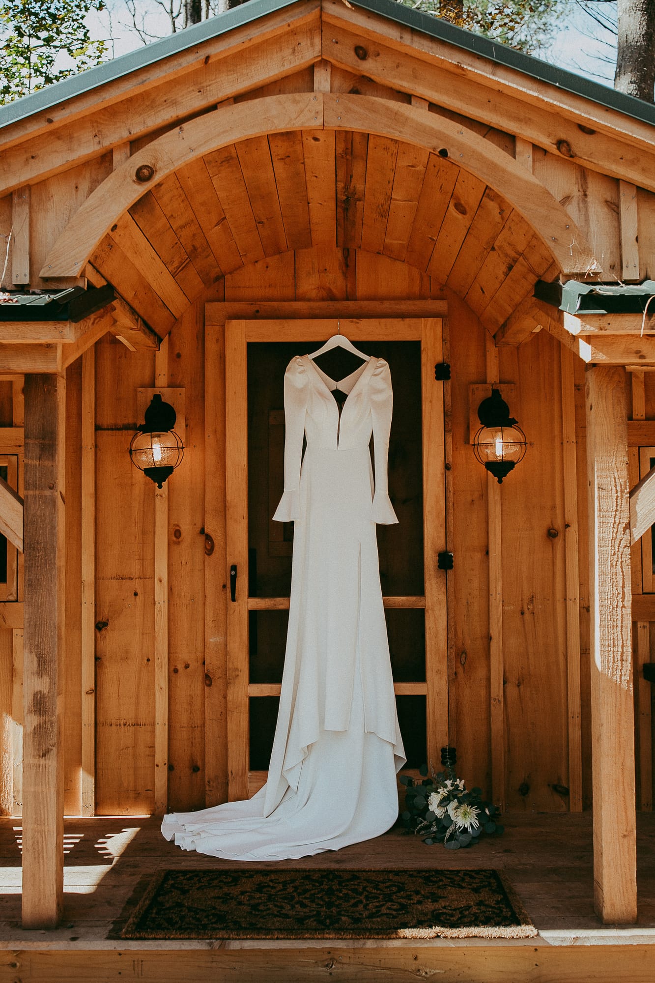 Wedding dress on the porch of a handbuilt cabin at Alpine Garden